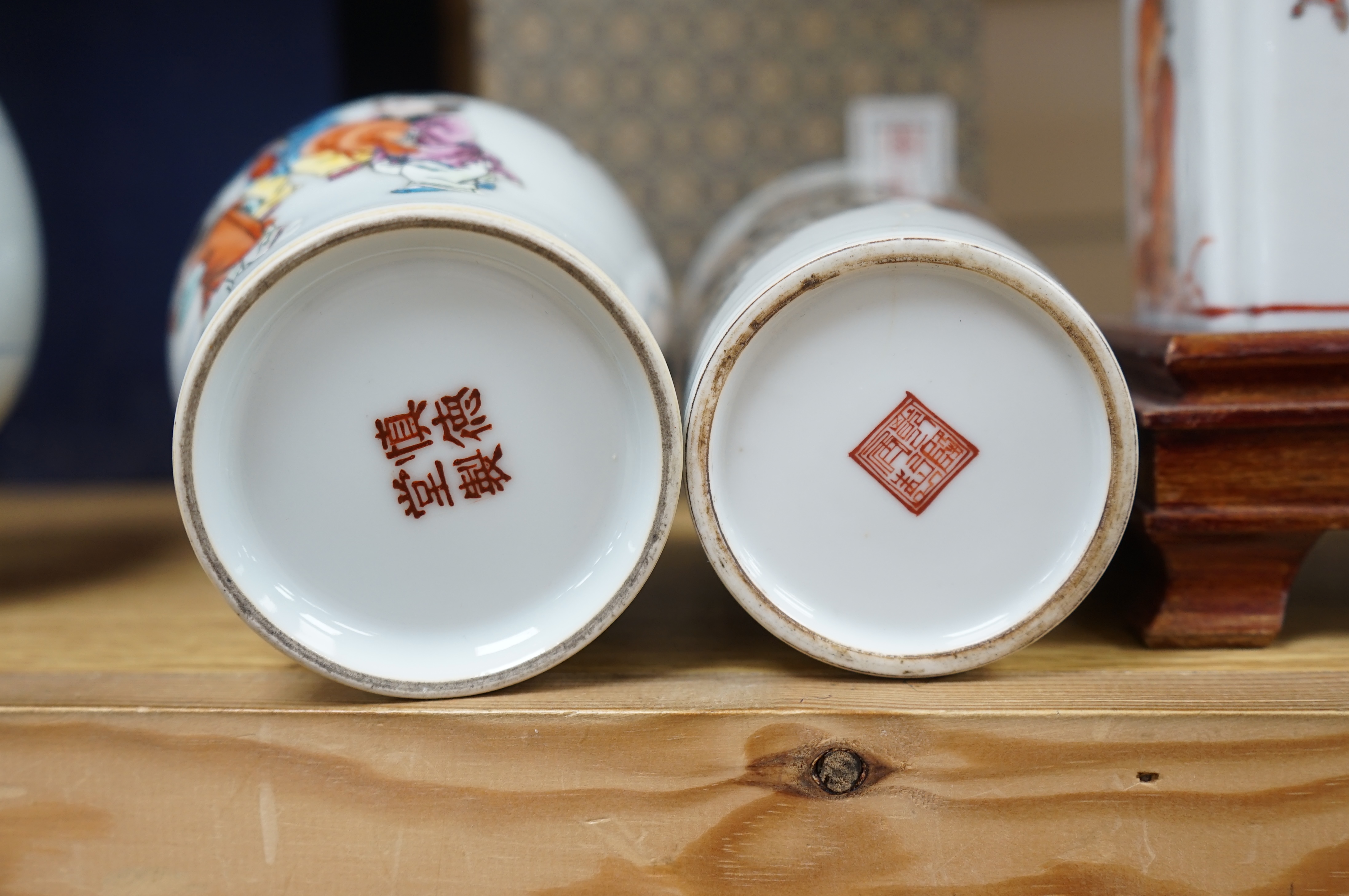 Two Chinese enamelled porcelain figure decorated vases, an underglaze blue and copper read garlic neck vase, and a rectangular jar with wood stand Condition - One vase cracked and chipped the rectangular jar lacking cove